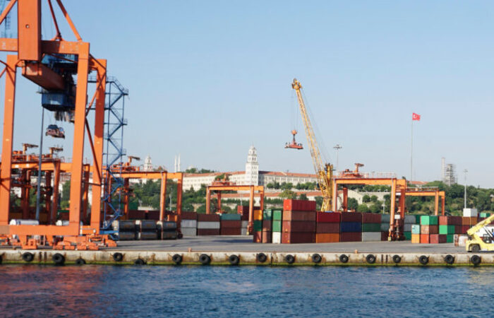 Crane lifting shipping containers at the seaport